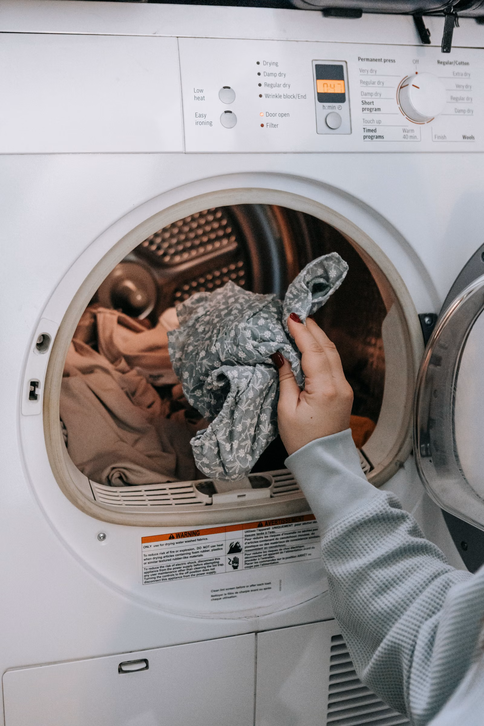 Loading a washing machine, one of the flexible household loads that can be shifted to a cheaper tariff period
