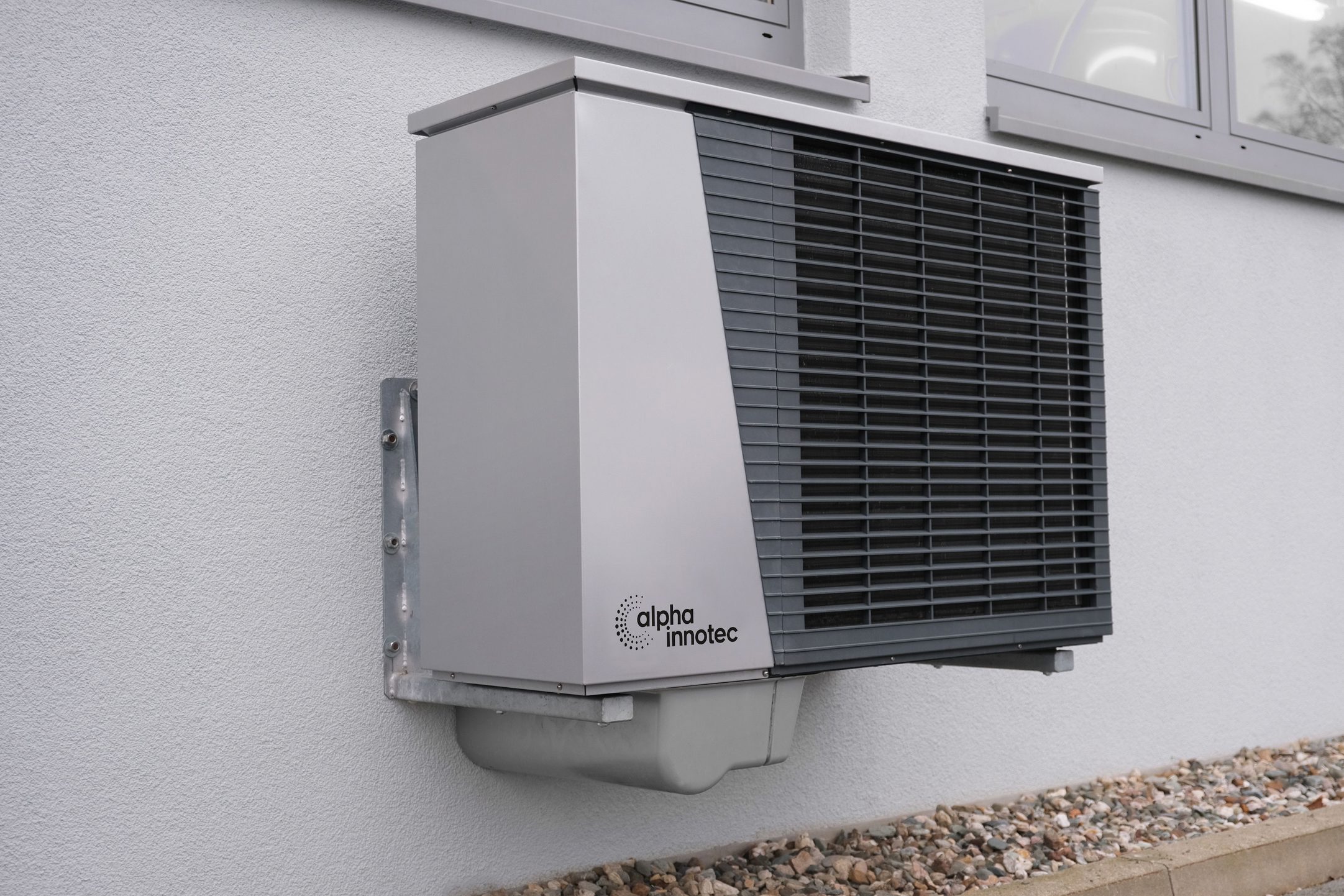 Outdoor heat-pump unit installed beside a residential building
